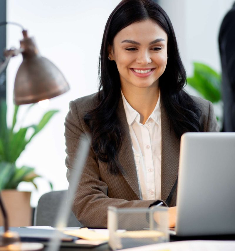 close up smiley woman working laptop